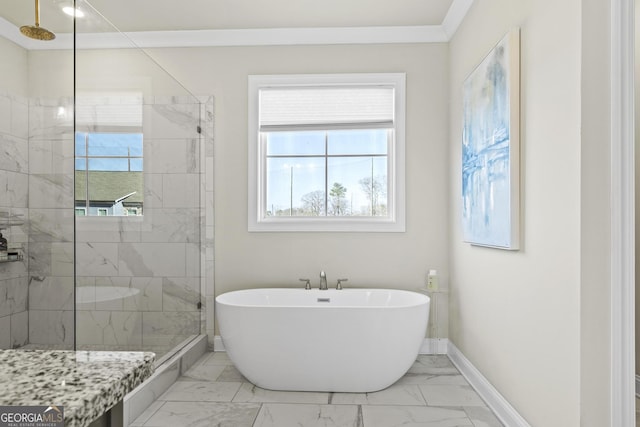 bathroom featuring baseboards, ornamental molding, a tile shower, a freestanding tub, and marble finish floor