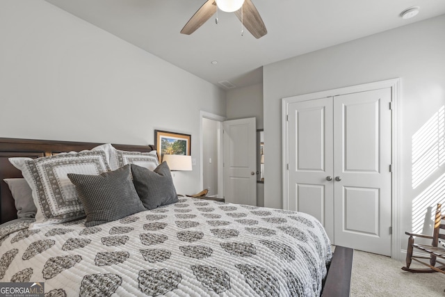 carpeted bedroom featuring visible vents, a closet, and ceiling fan