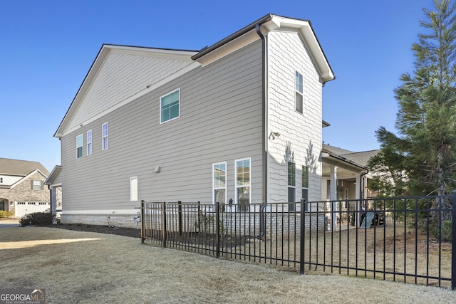 view of side of property featuring fence