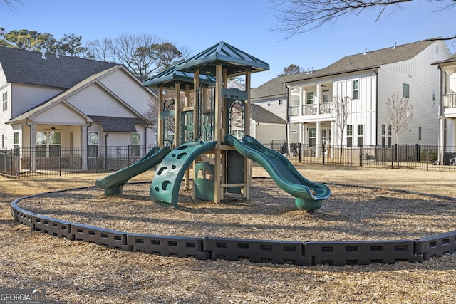 community jungle gym with fence and a residential view