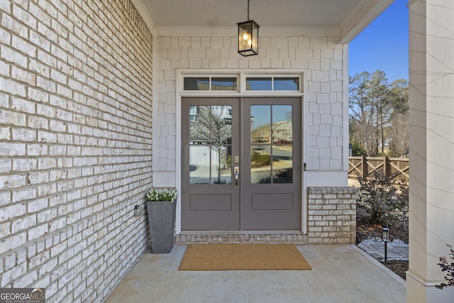 doorway to property with french doors and fence