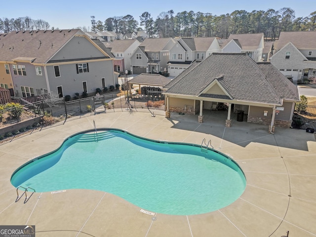 pool with a patio area, a residential view, a gazebo, and fence