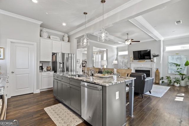 kitchen featuring dark wood finished floors, visible vents, appliances with stainless steel finishes, and a sink