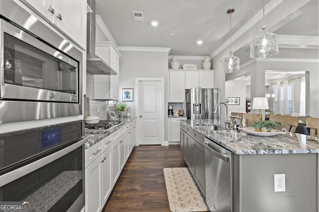 kitchen with tasteful backsplash, crown molding, light stone counters, appliances with stainless steel finishes, and a sink