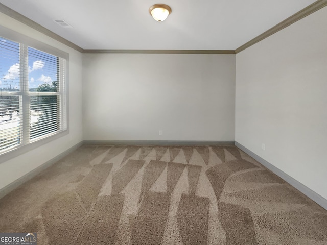 empty room with light carpet, visible vents, baseboards, and ornamental molding