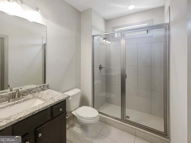 full bathroom with vanity, toilet, a shower stall, and tile patterned flooring