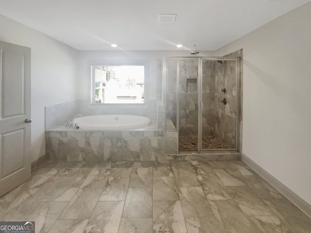 bathroom featuring marble finish floor, a stall shower, baseboards, and a garden tub