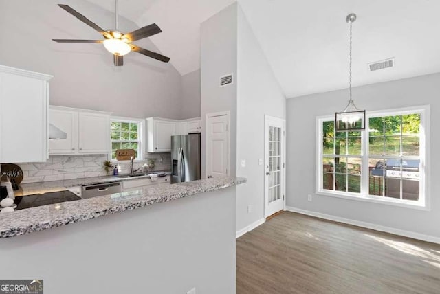 kitchen with visible vents, white cabinets, stainless steel appliances, and a sink