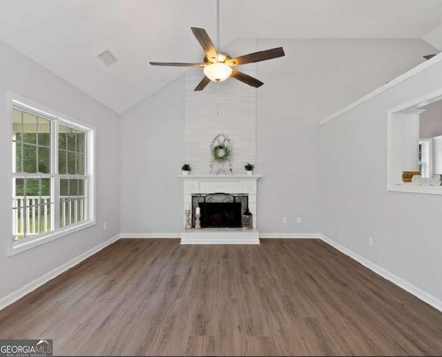 unfurnished living room featuring a fireplace, baseboards, a ceiling fan, and vaulted ceiling