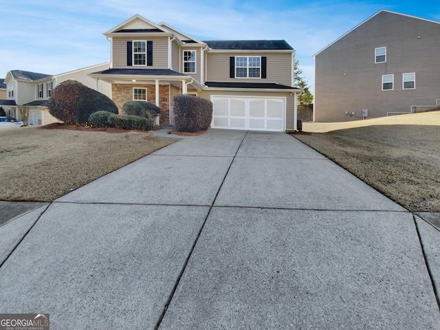 view of front of home featuring concrete driveway and an attached garage