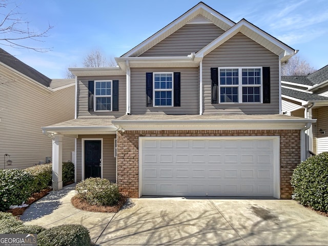 traditional-style house with brick siding, concrete driveway, and an attached garage