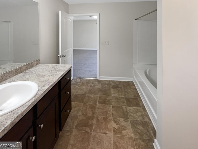 bathroom featuring vanity, shower / bathtub combination, and baseboards