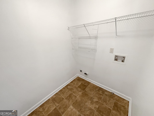 laundry room featuring laundry area, hookup for a washing machine, electric dryer hookup, and baseboards