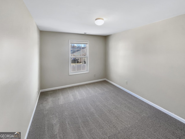 carpeted spare room with baseboards