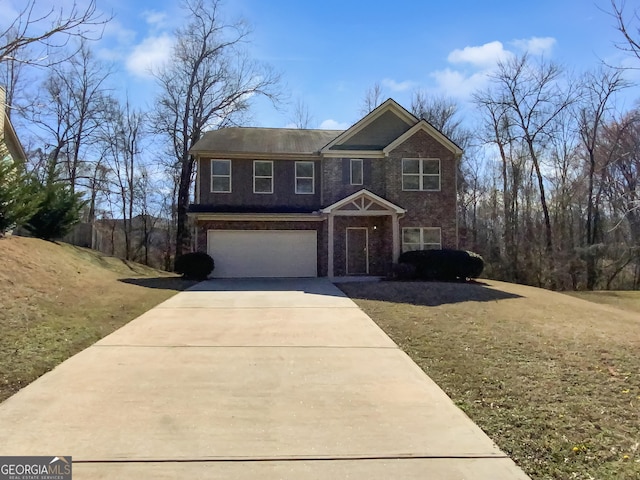 view of front of home with a front lawn, an attached garage, brick siding, and driveway