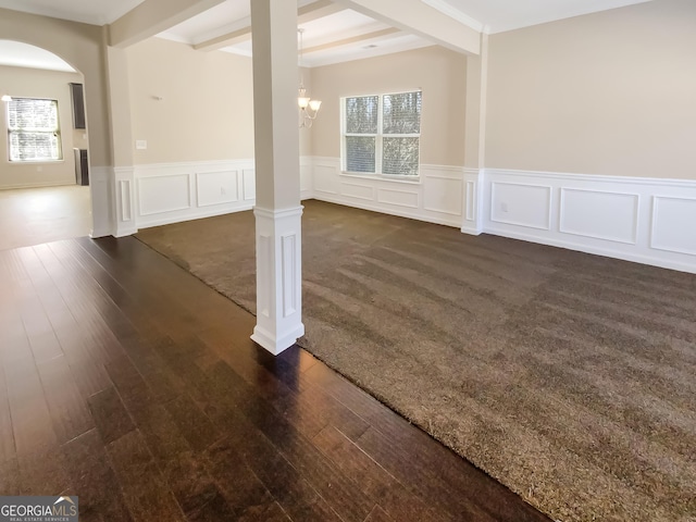 interior space with dark wood-type flooring, beamed ceiling, arched walkways, and ornate columns