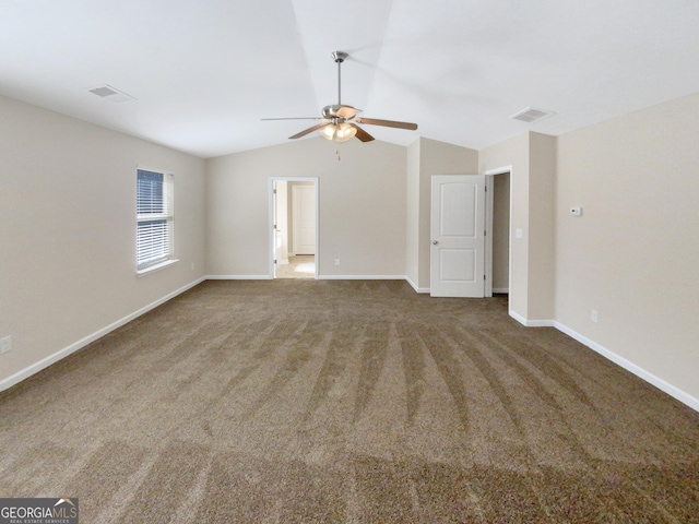 unfurnished living room featuring visible vents, baseboards, carpet floors, and vaulted ceiling