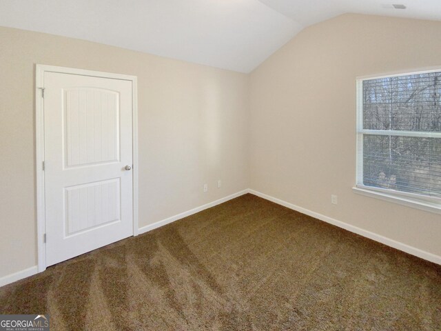 interior space featuring baseboards and lofted ceiling