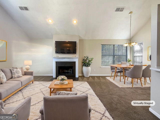 living room with vaulted ceiling, a fireplace with flush hearth, visible vents, and a chandelier