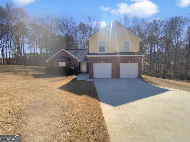 traditional home with driveway, brick siding, an attached garage, and a front yard