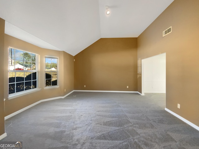 unfurnished room featuring visible vents, baseboards, carpet flooring, and vaulted ceiling