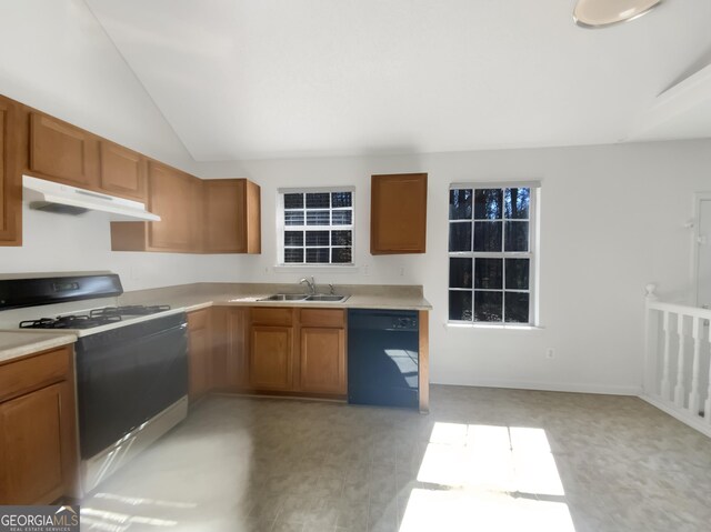 kitchen featuring under cabinet range hood, a sink, black dishwasher, gas range oven, and light countertops