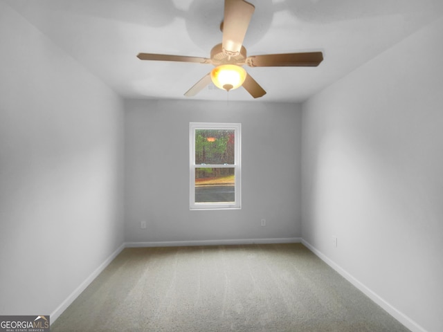 carpeted empty room with baseboards and ceiling fan