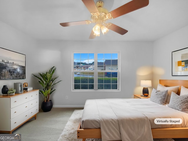 carpeted bedroom featuring baseboards and ceiling fan