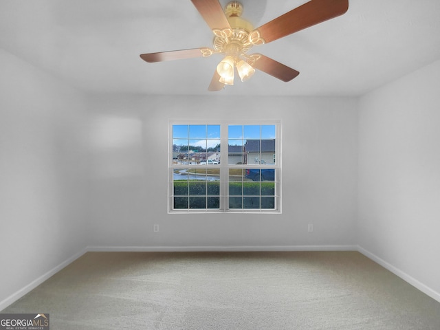 empty room featuring a ceiling fan, baseboards, and carpet floors