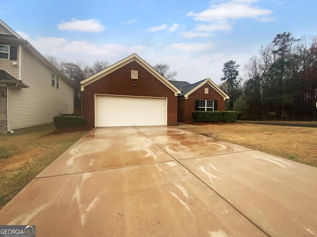 view of front of property with concrete driveway, an attached garage, brick siding, and a front lawn