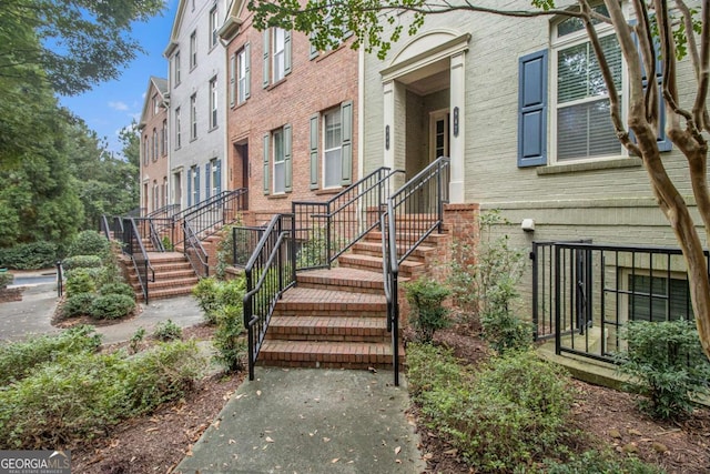 doorway to property featuring brick siding