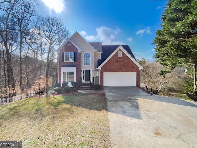 traditional home featuring a front lawn, driveway, fence, a garage, and brick siding