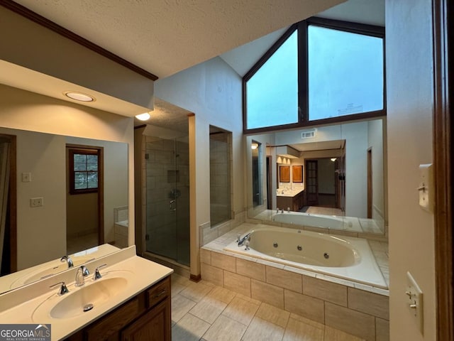 full bath with vanity, a tub with jets, visible vents, a stall shower, and a textured ceiling