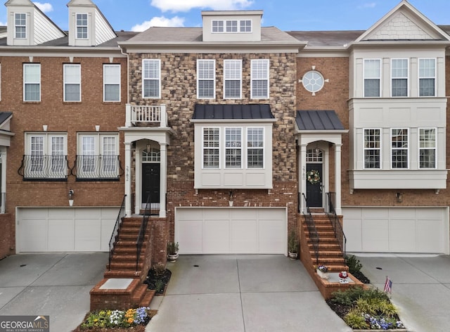 multi unit property featuring brick siding, roof with shingles, concrete driveway, and an attached garage