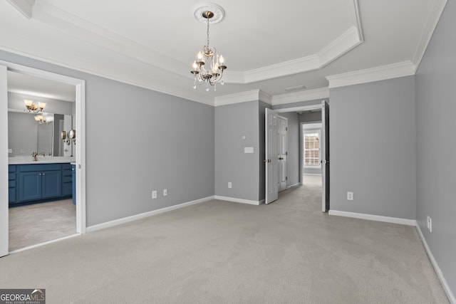 unfurnished bedroom featuring a tray ceiling, light colored carpet, baseboards, and a chandelier