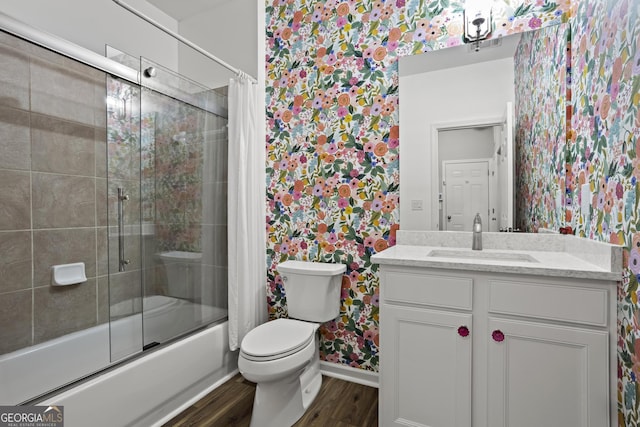 full bathroom with vanity, wood finished floors, visible vents, shower / bath combination with glass door, and toilet