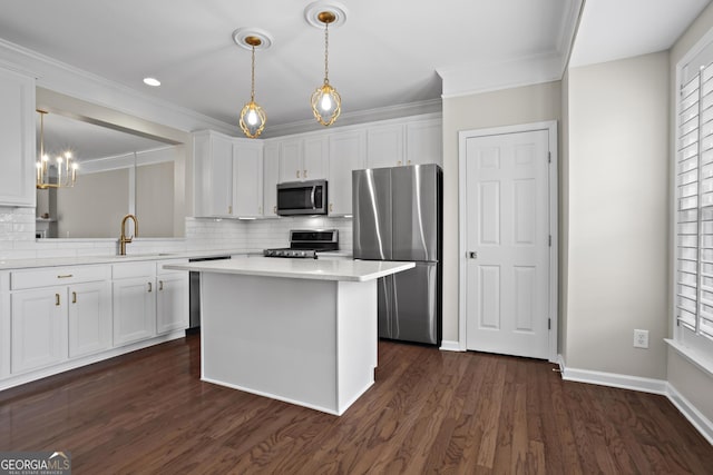 kitchen with a kitchen island, a sink, light countertops, white cabinets, and appliances with stainless steel finishes