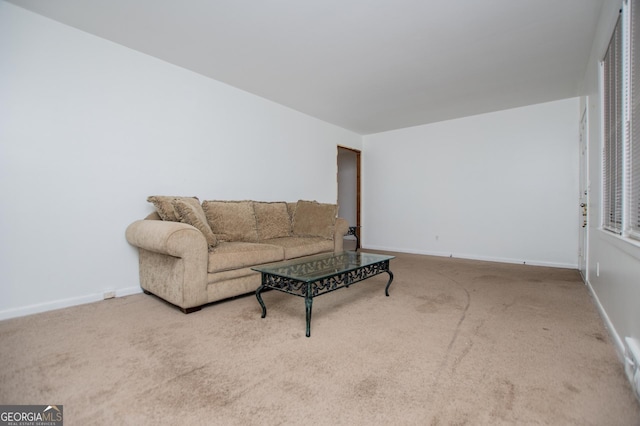 carpeted living room with baseboards