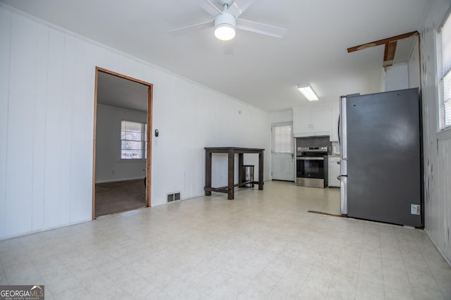 kitchen featuring visible vents, light floors, white cabinets, and stainless steel appliances