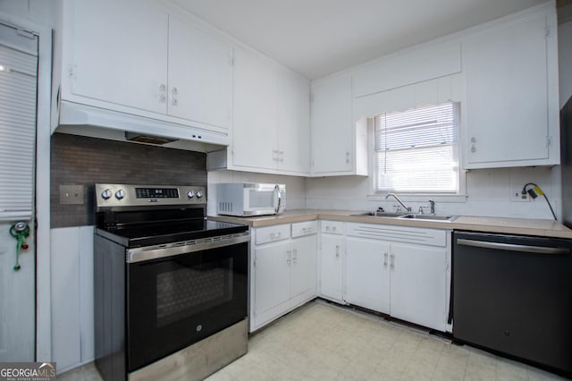 kitchen featuring white microwave, under cabinet range hood, dishwashing machine, electric stove, and a sink