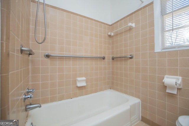 bathroom with shower / bath combination and toilet