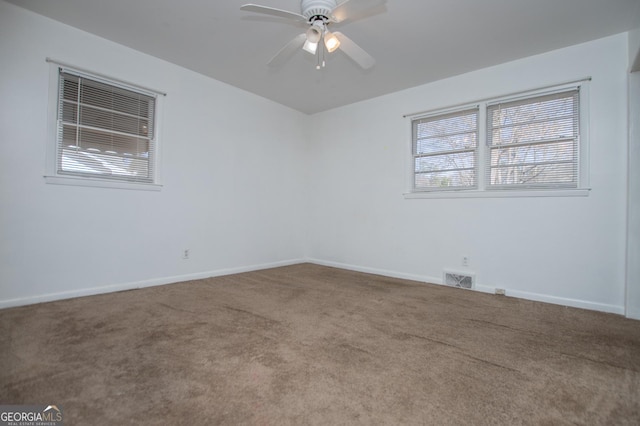 unfurnished room featuring carpet flooring, baseboards, and ceiling fan