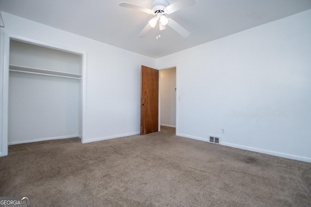 unfurnished bedroom with visible vents, a closet, carpet, baseboards, and ceiling fan