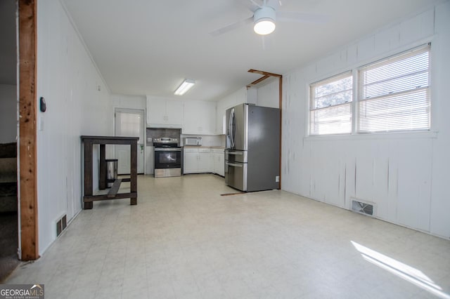 kitchen featuring white cabinetry, light floors, visible vents, and appliances with stainless steel finishes