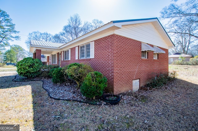 view of side of property featuring brick siding