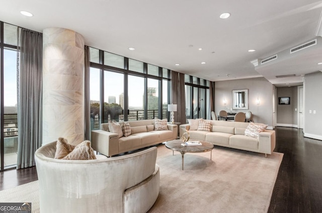 living room featuring recessed lighting, visible vents, floor to ceiling windows, and wood finished floors