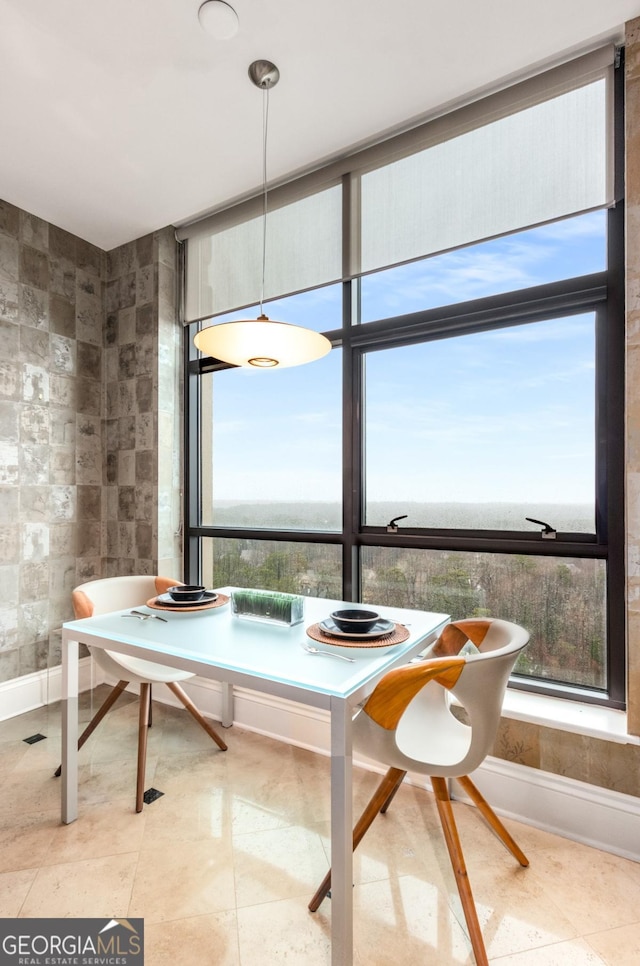 dining space with tile walls and tile patterned floors