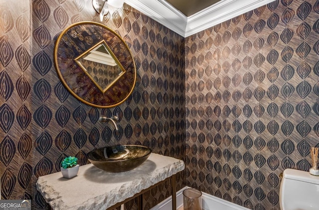 half bath featuring toilet and crown molding