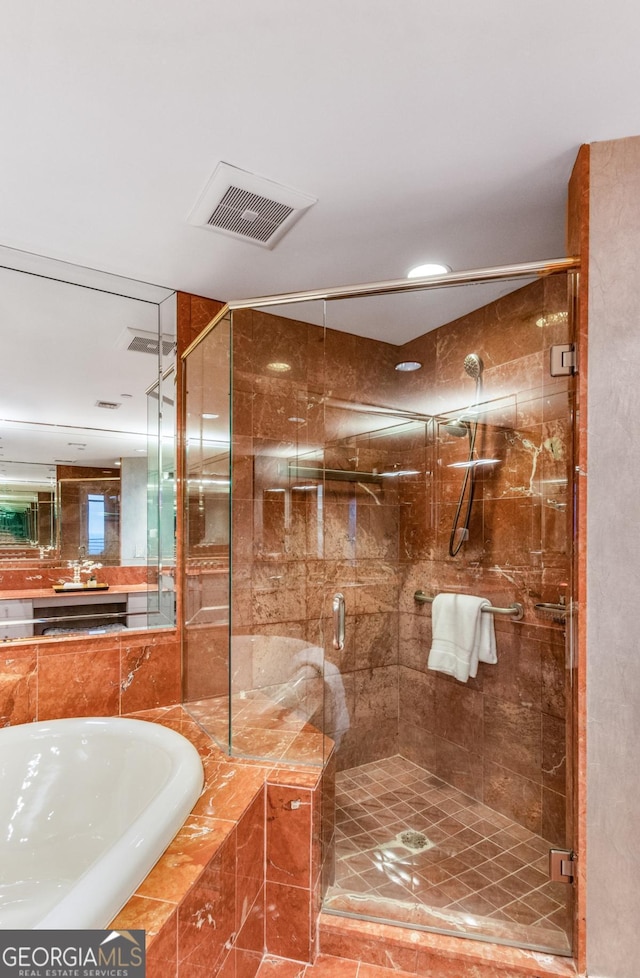 full bath featuring a bath, visible vents, a shower stall, and vanity