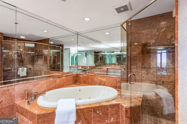 bathroom with recessed lighting, visible vents, a jetted tub, and a stall shower